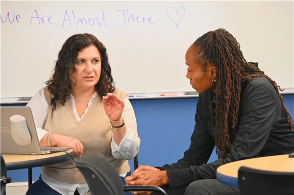 Challa Holland talking to an employee