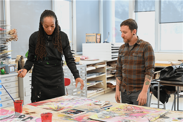 Two staff members at an art event